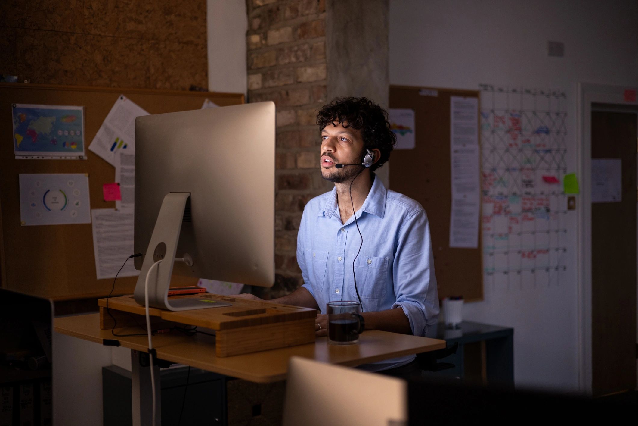 Person working at a standing desk with a computer
